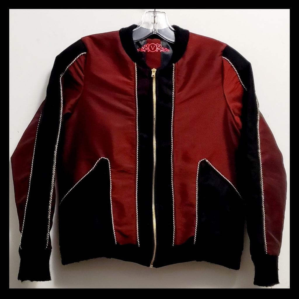 Front view of red taffeta and black velveteen colour-blocked bomber jacket with white cord piping
