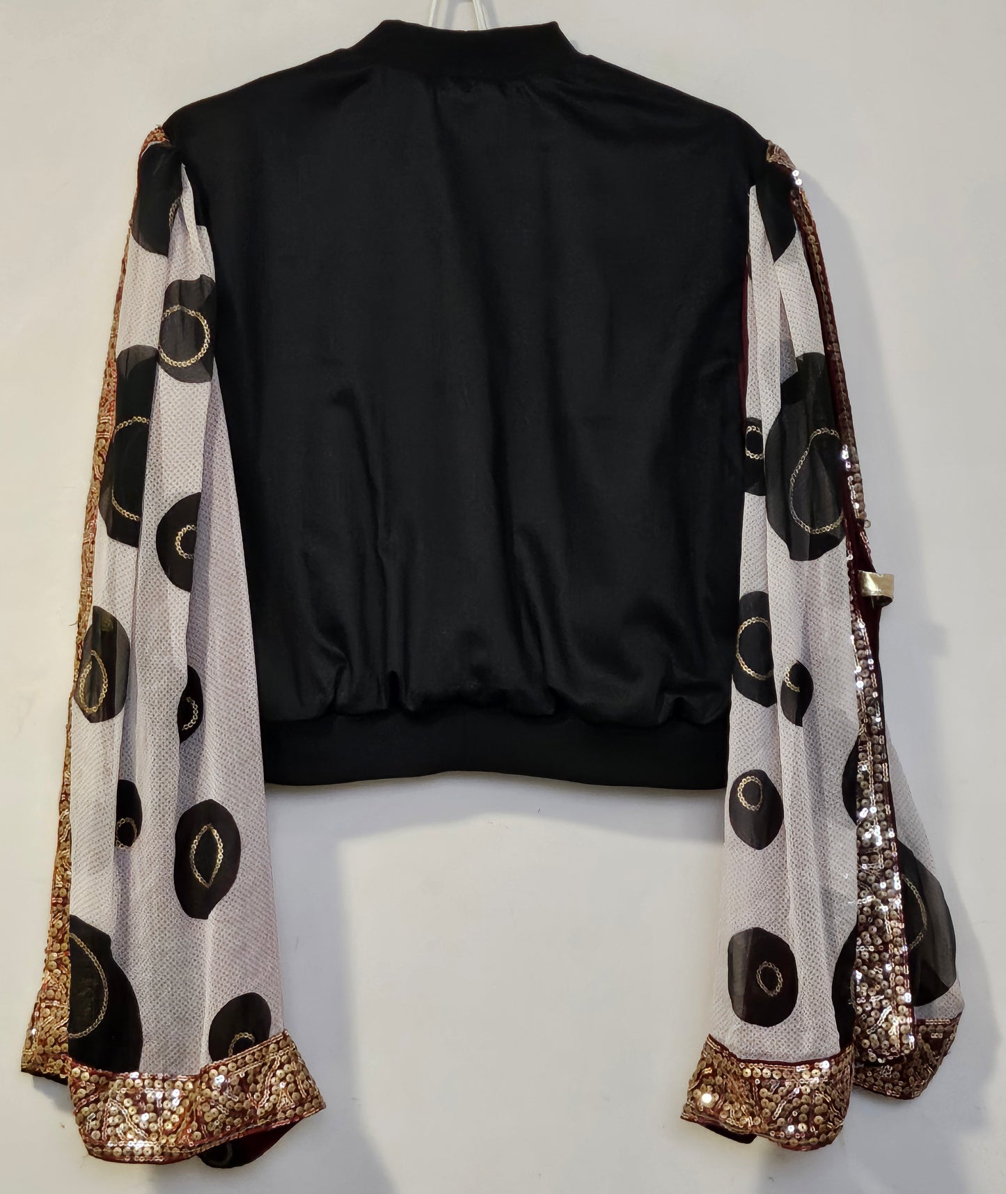 Back view of Indian inspired bomber jacket with sheer cape sleeves