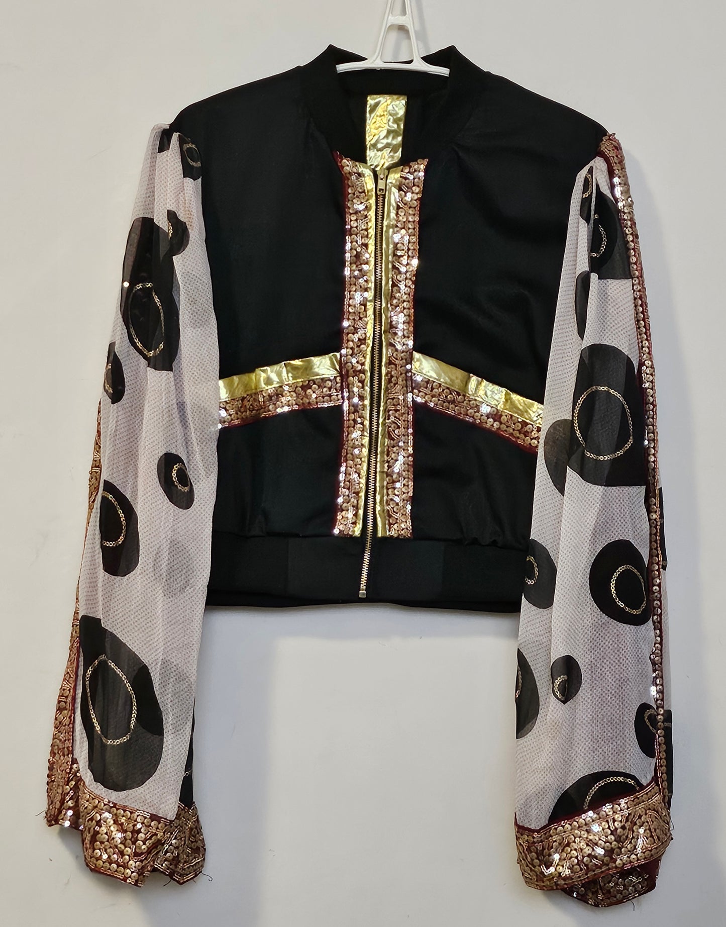 Front view of Indian inspired bomber jacket with sheer cape sleeves