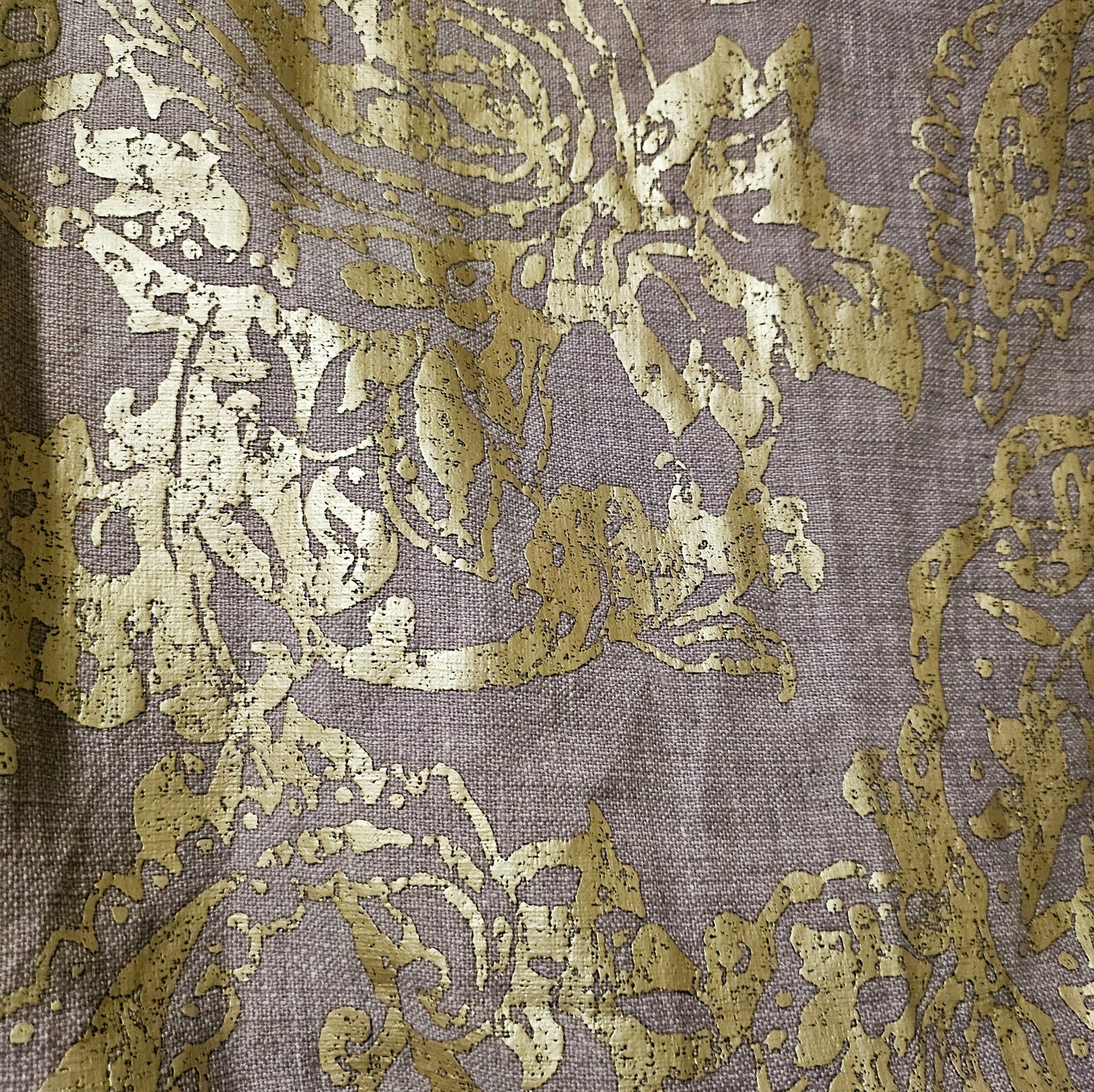 Fabric view of Lilac linen blend embossed with a golden baroque pattern