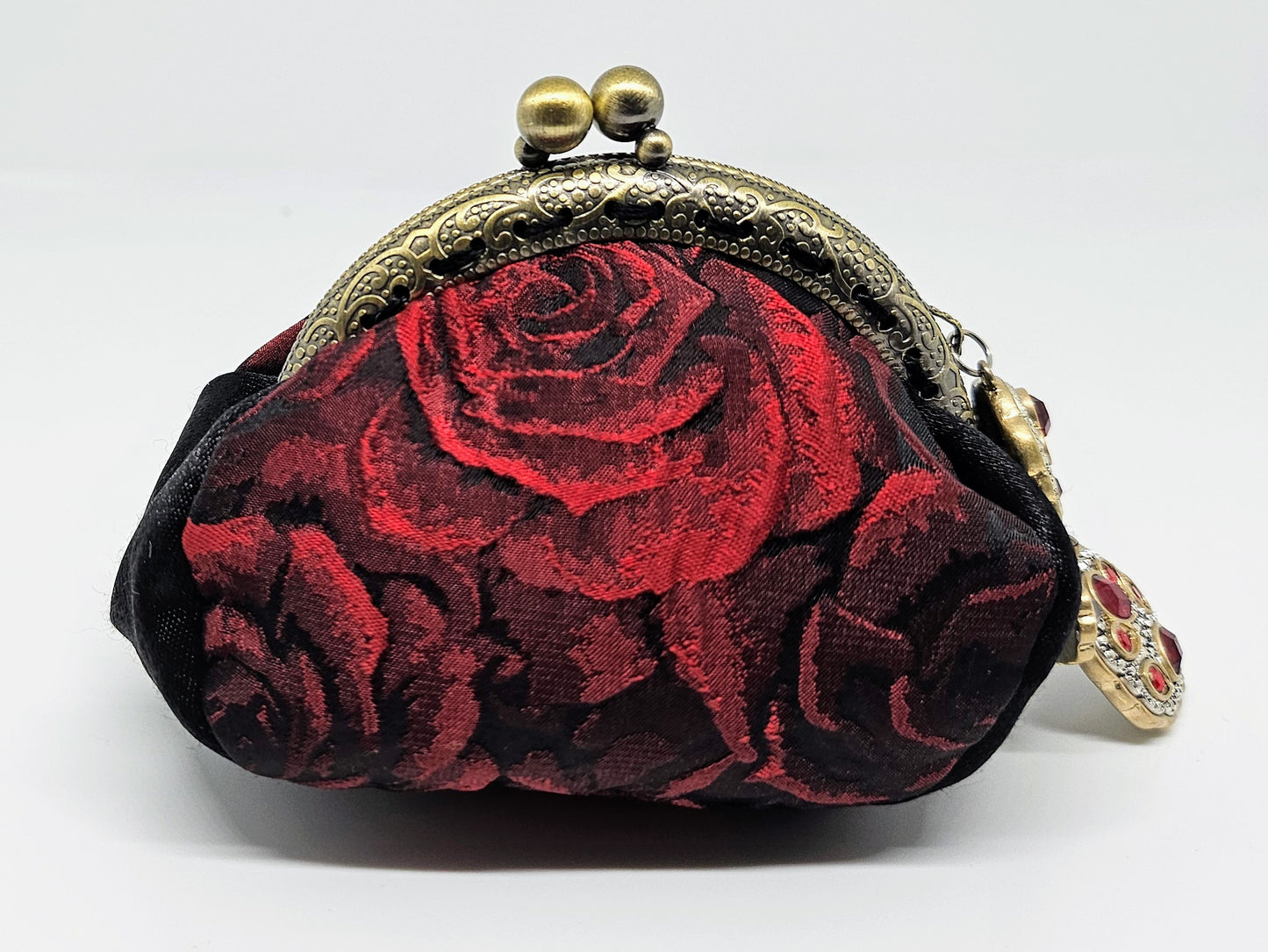 Front view of 3D rose print kiss clasp coin purse with ornated jeweled charm
