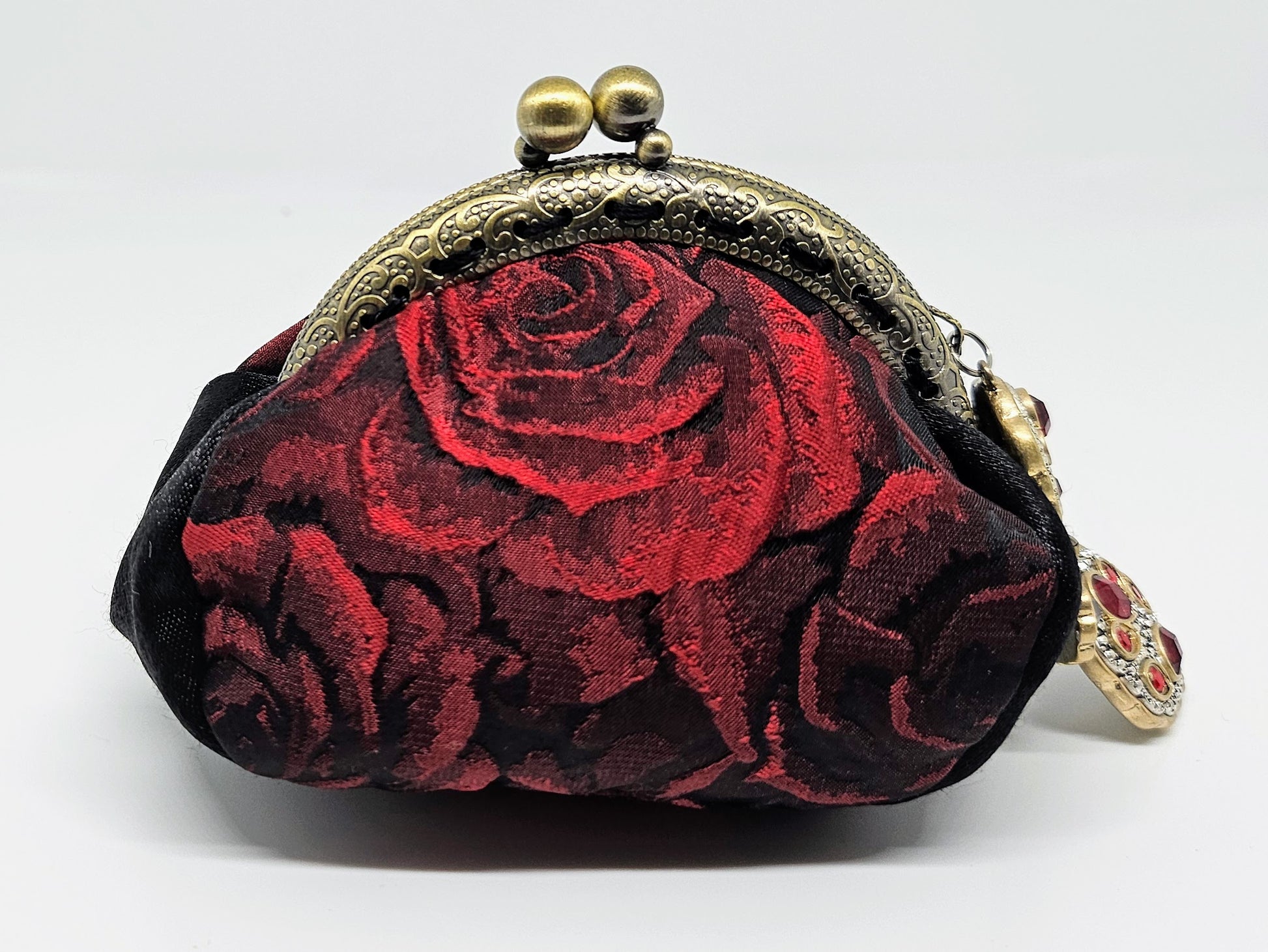 Front view of 3D rose print kiss clasp coin purse with ornated jeweled charm