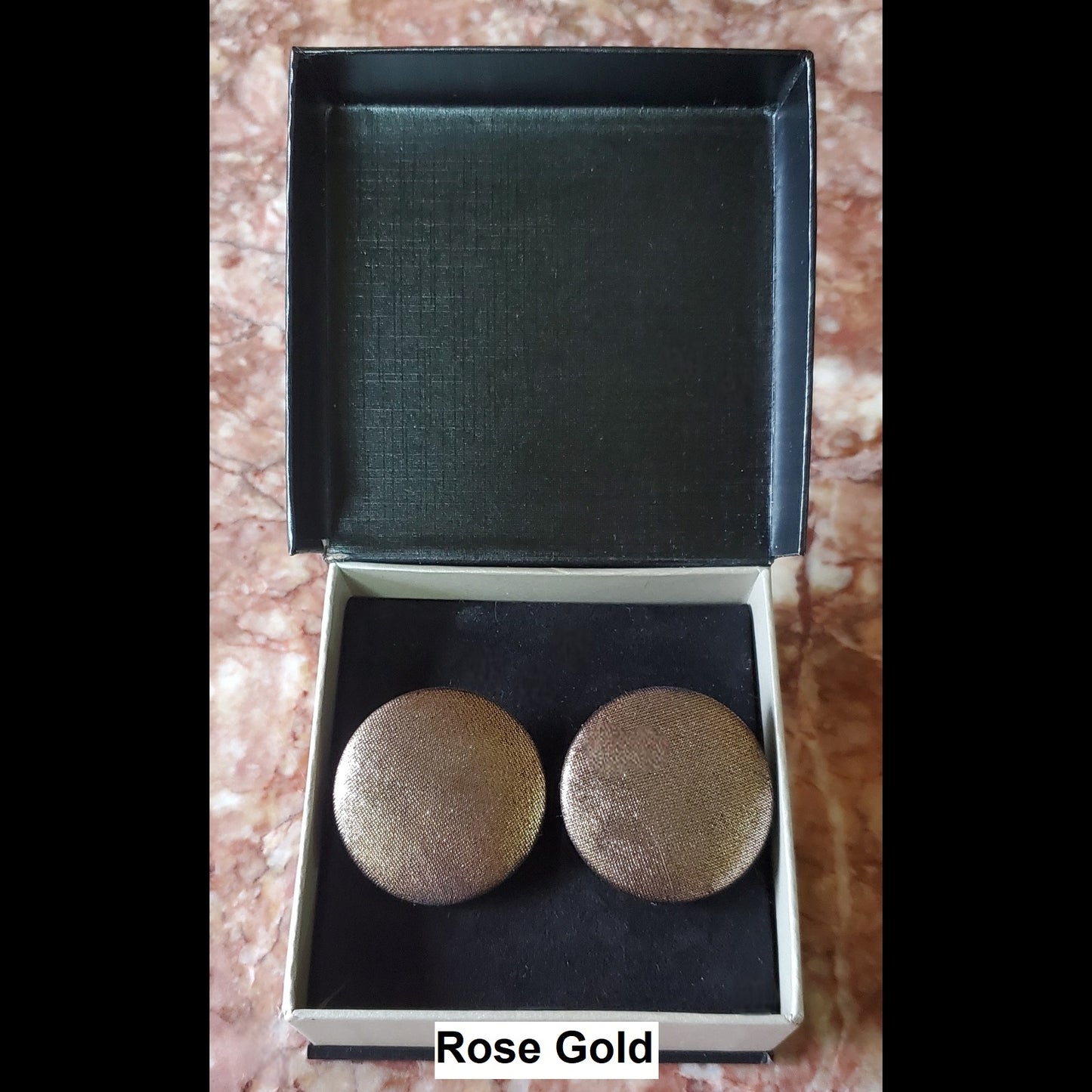 Rose gold button earrings in jewelry box