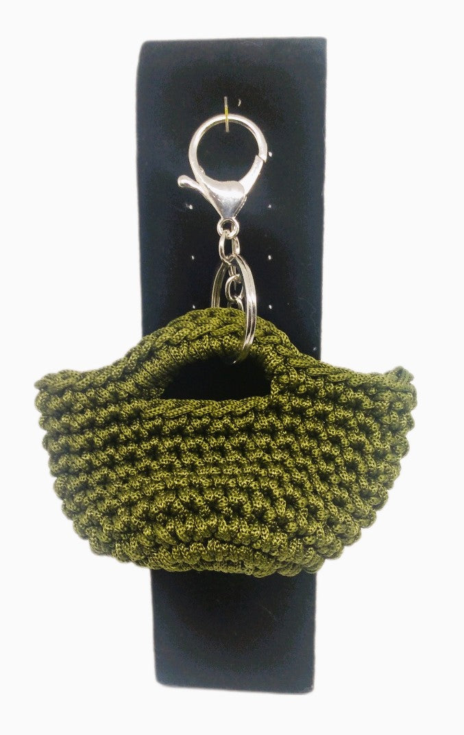 Front view of Olive green/silver mini handbag keychain on stand