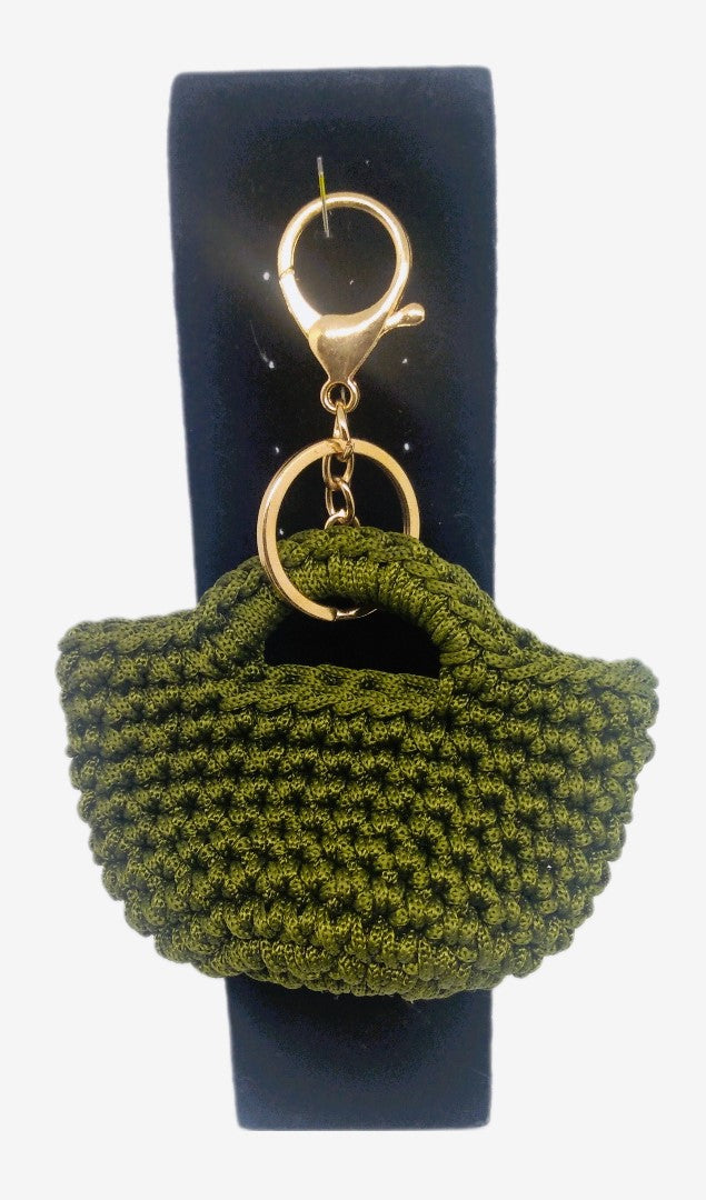 Front view of Olive green/gold mini handbag keychain on stand