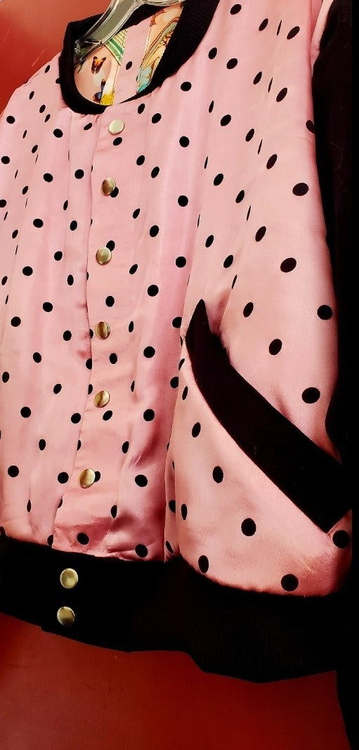 side front view of pink polka dot varsity jacket