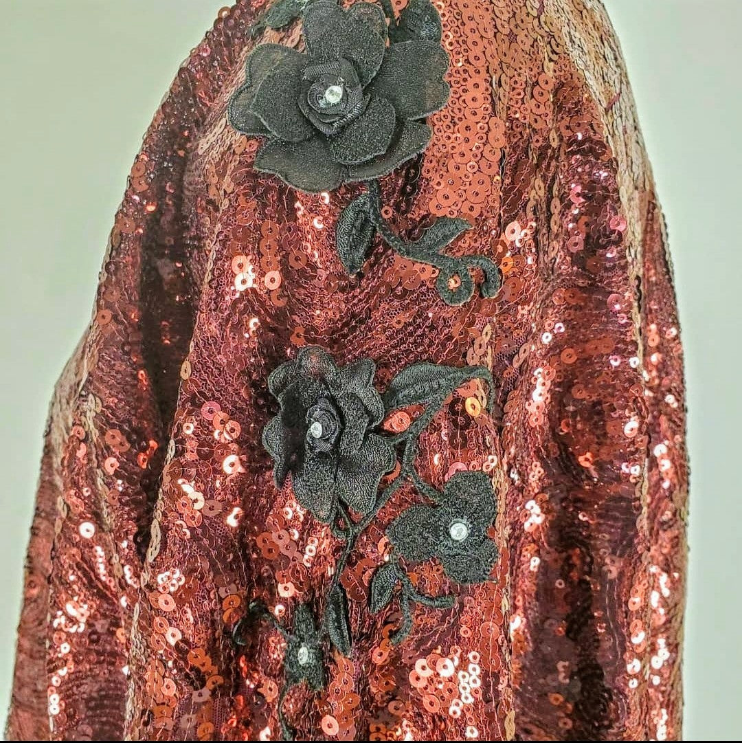 side view of Burgundy sequin kimono jacket with black embroidered shoulders on mannequin