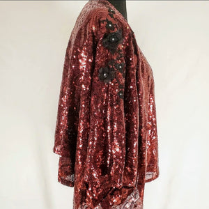 full side view of Burgundy sequin kimono jacket with black embroidered shoulders on mannequin