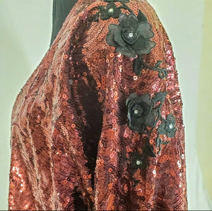 close up view of Burgundy sequin kimono jacket with black embroidered shoulders on mannequin