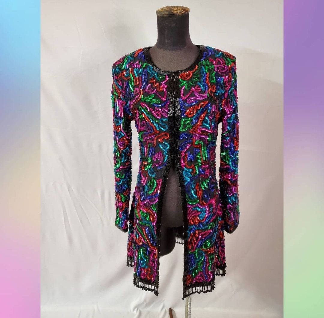 front view of Rainbow sequined jacket dress with fringe details on mannequin