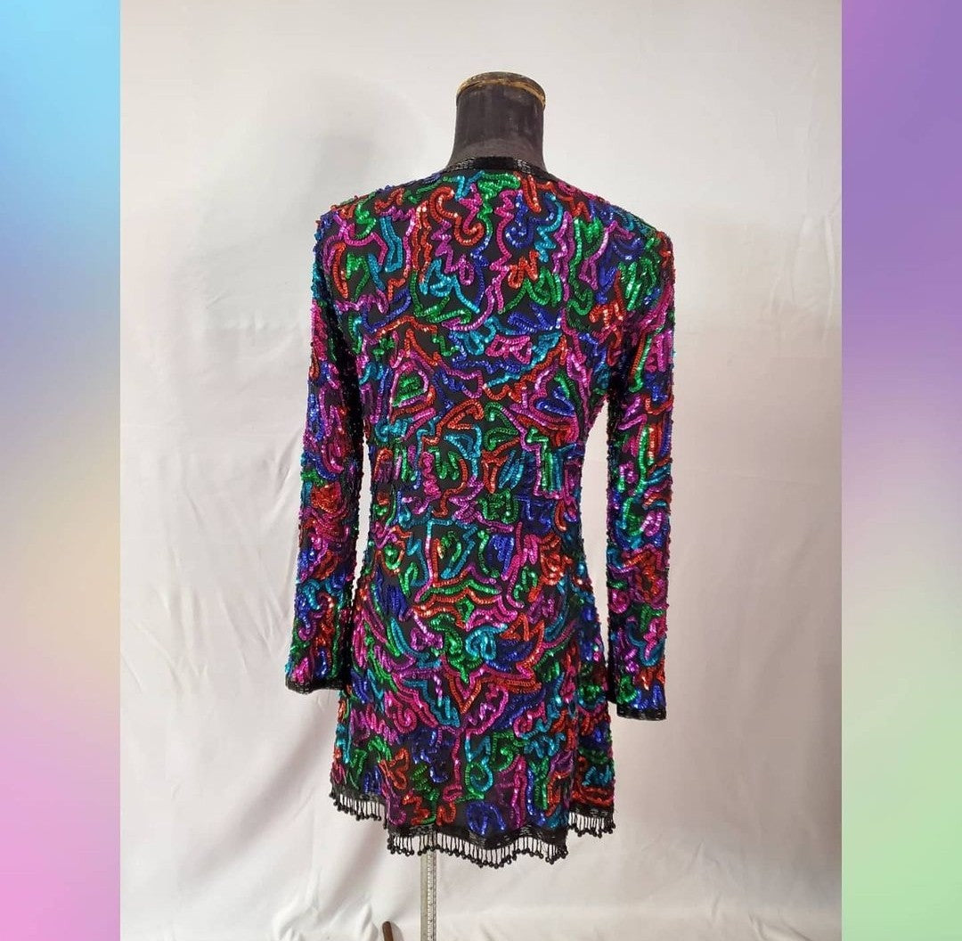 back view of Rainbow sequined jacket dress with fringe details on mannequin