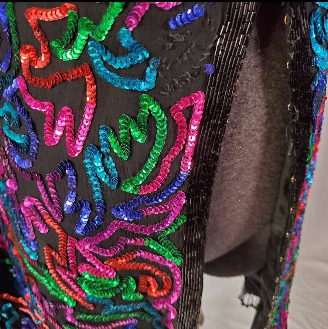 close up of beaded hook and eye front of Rainbow sequined jacket dress with fringe details