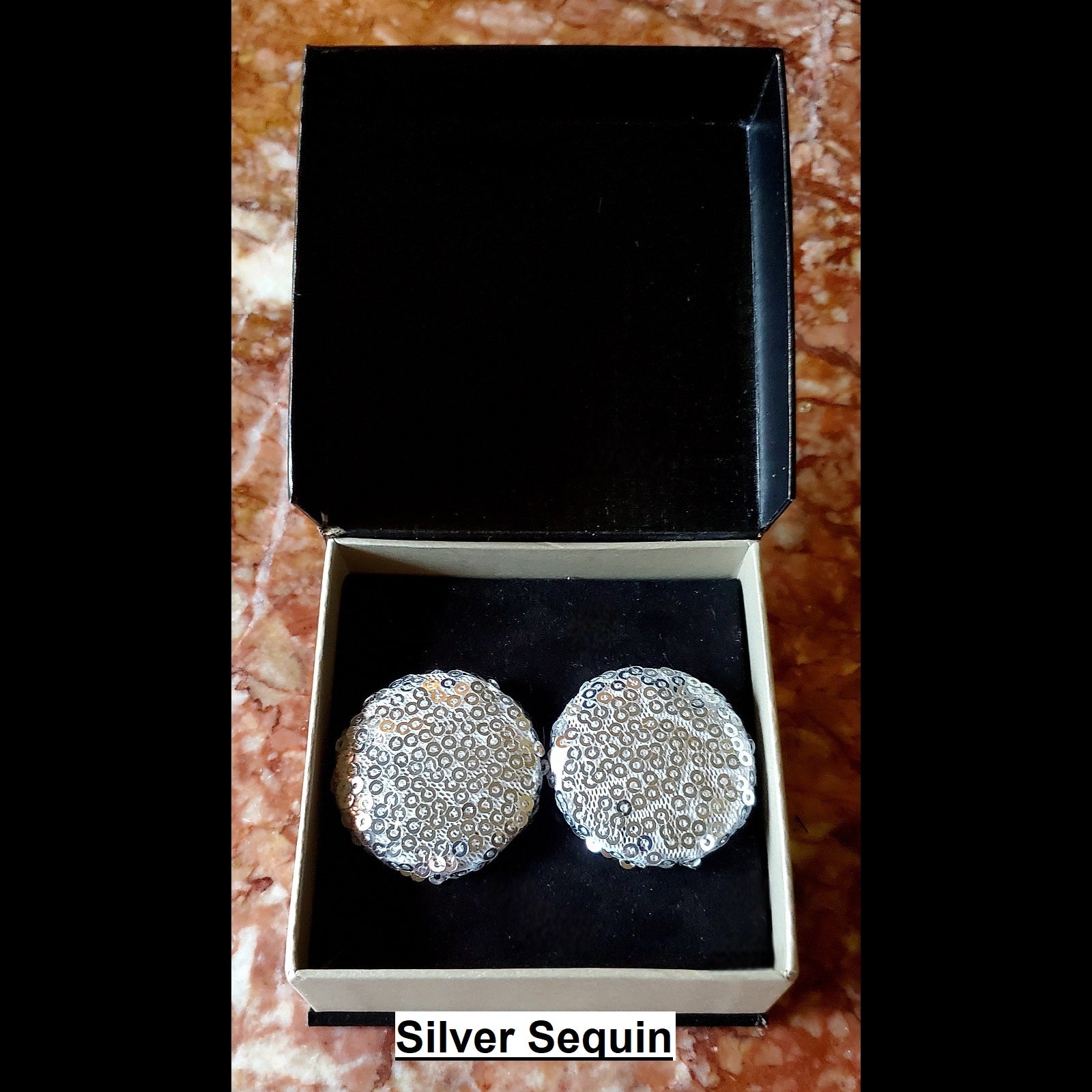 Silver sequin button earrings in jewelry box