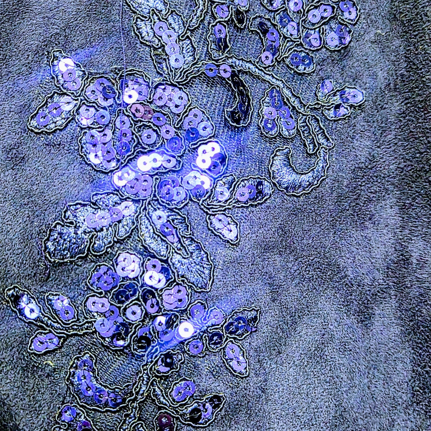 Close-up of a sequined design on a fabric surface