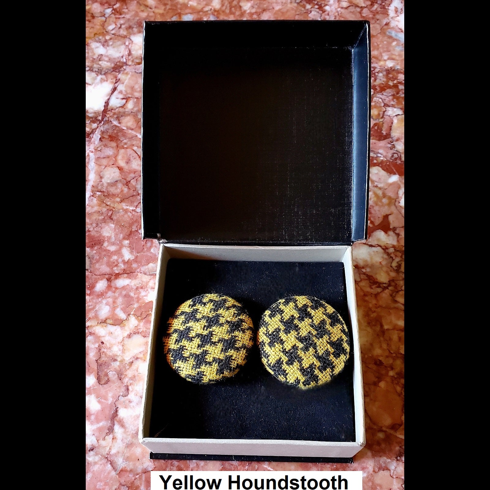 Yellow houndstooth print button earrings in jewelry box