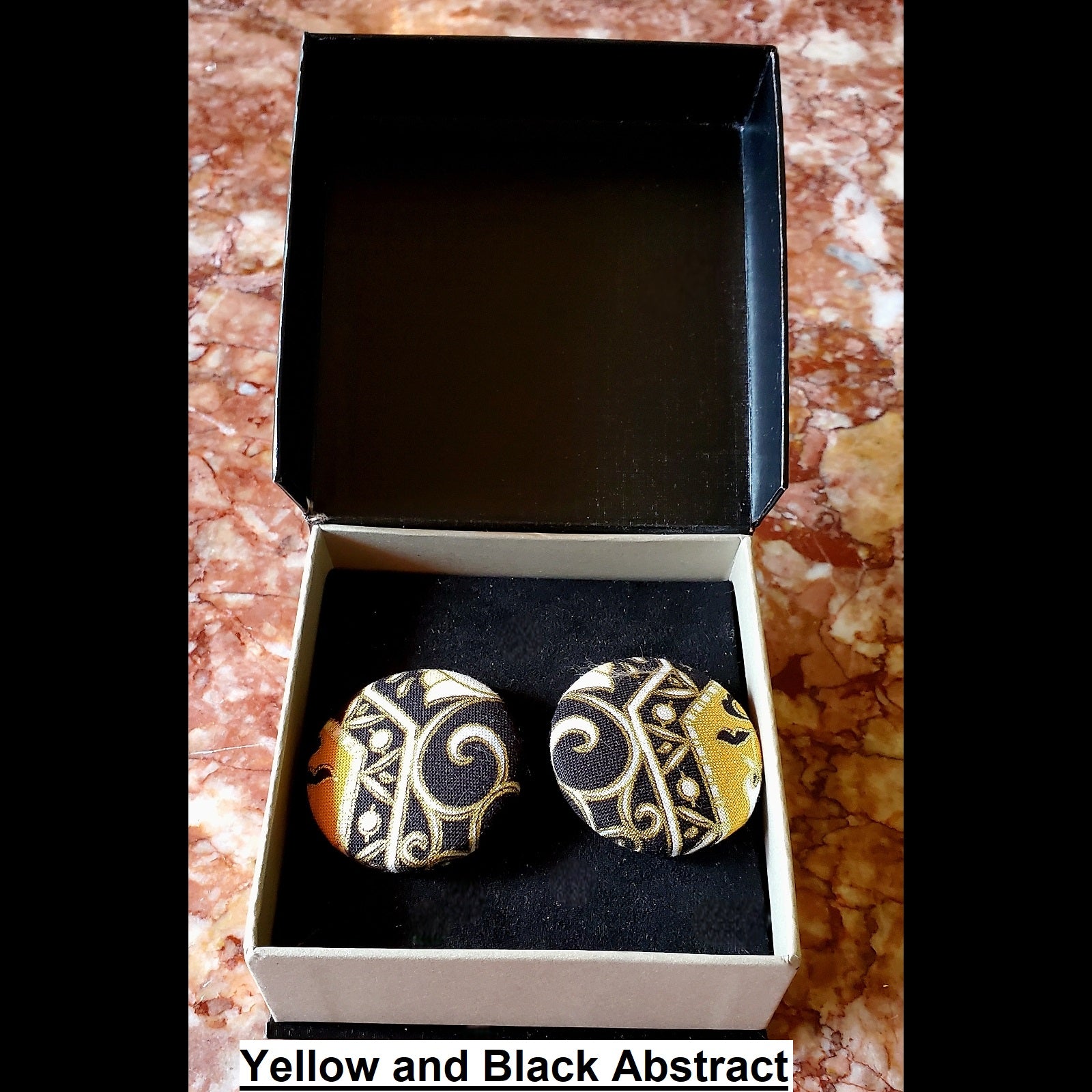 Yellow, black and white abstract print button earrings in jewelry box