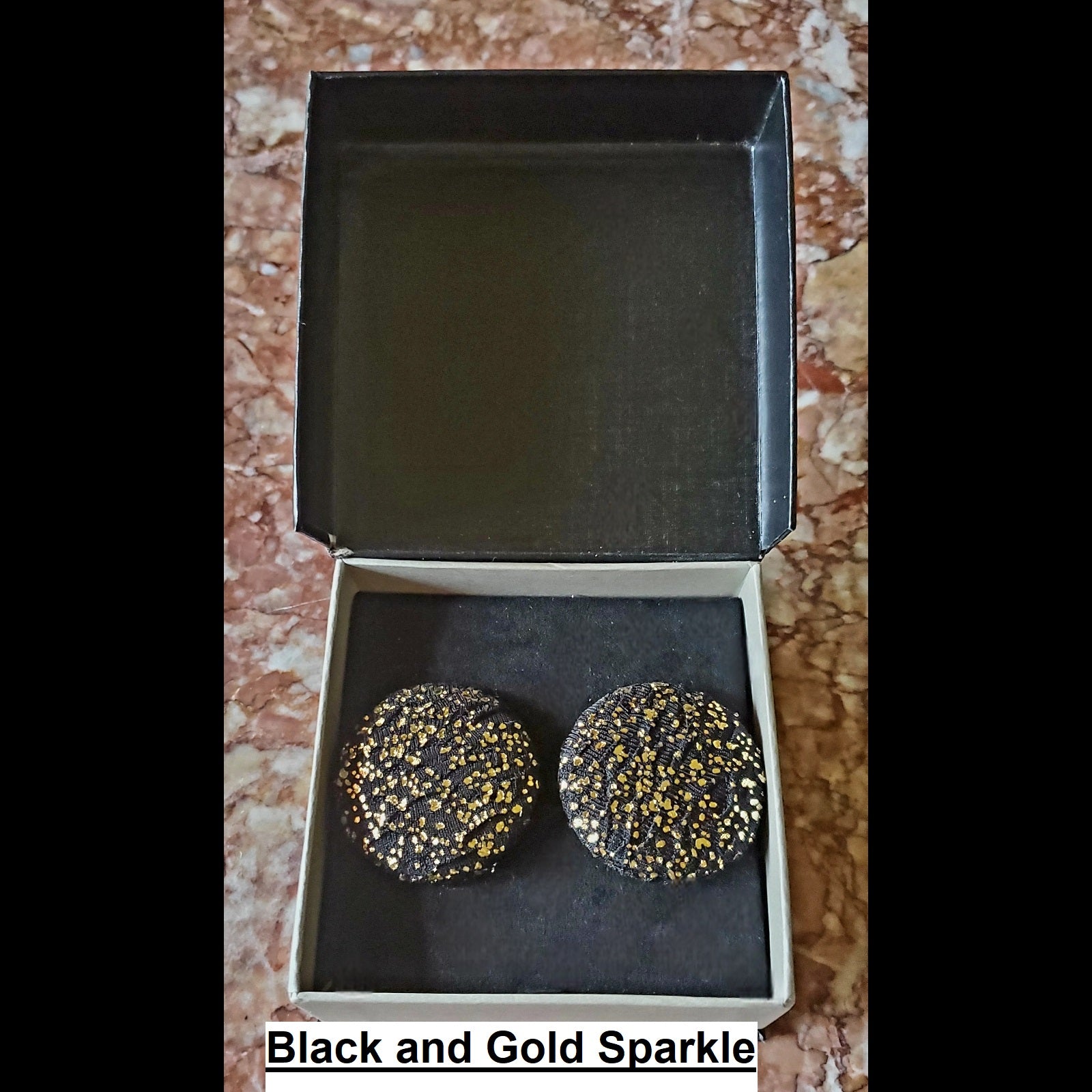 Black and gold sparkle print button earrings in jewelry box