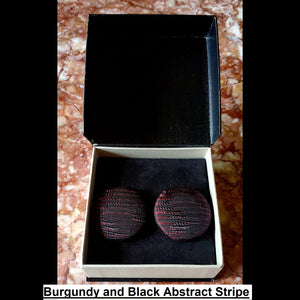 Burgundy and black abstract stripe print button earrings in jewelry box