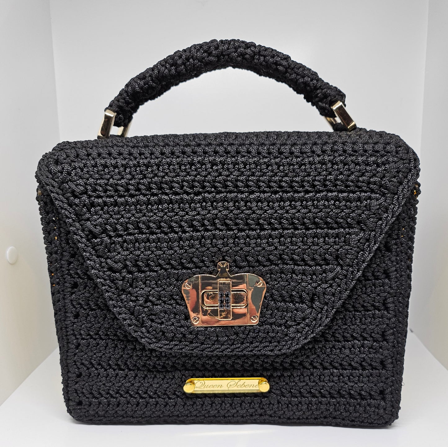 Front view of Structured black crochet handbag with custom made laser cut acrylic sides