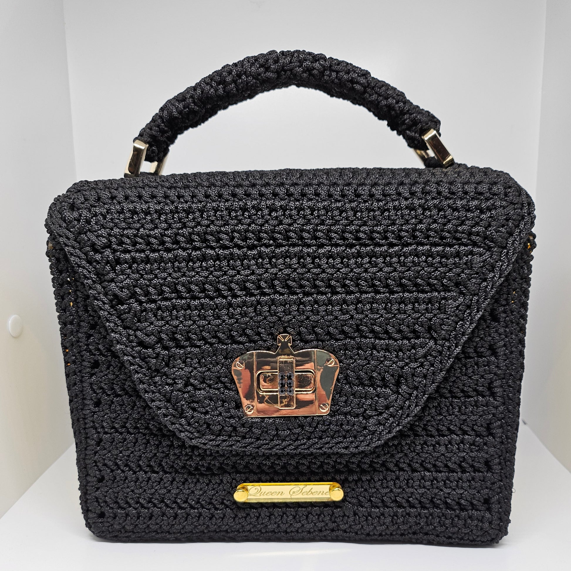 Front view of Structured black crochet handbag with custom made laser cut acrylic sides