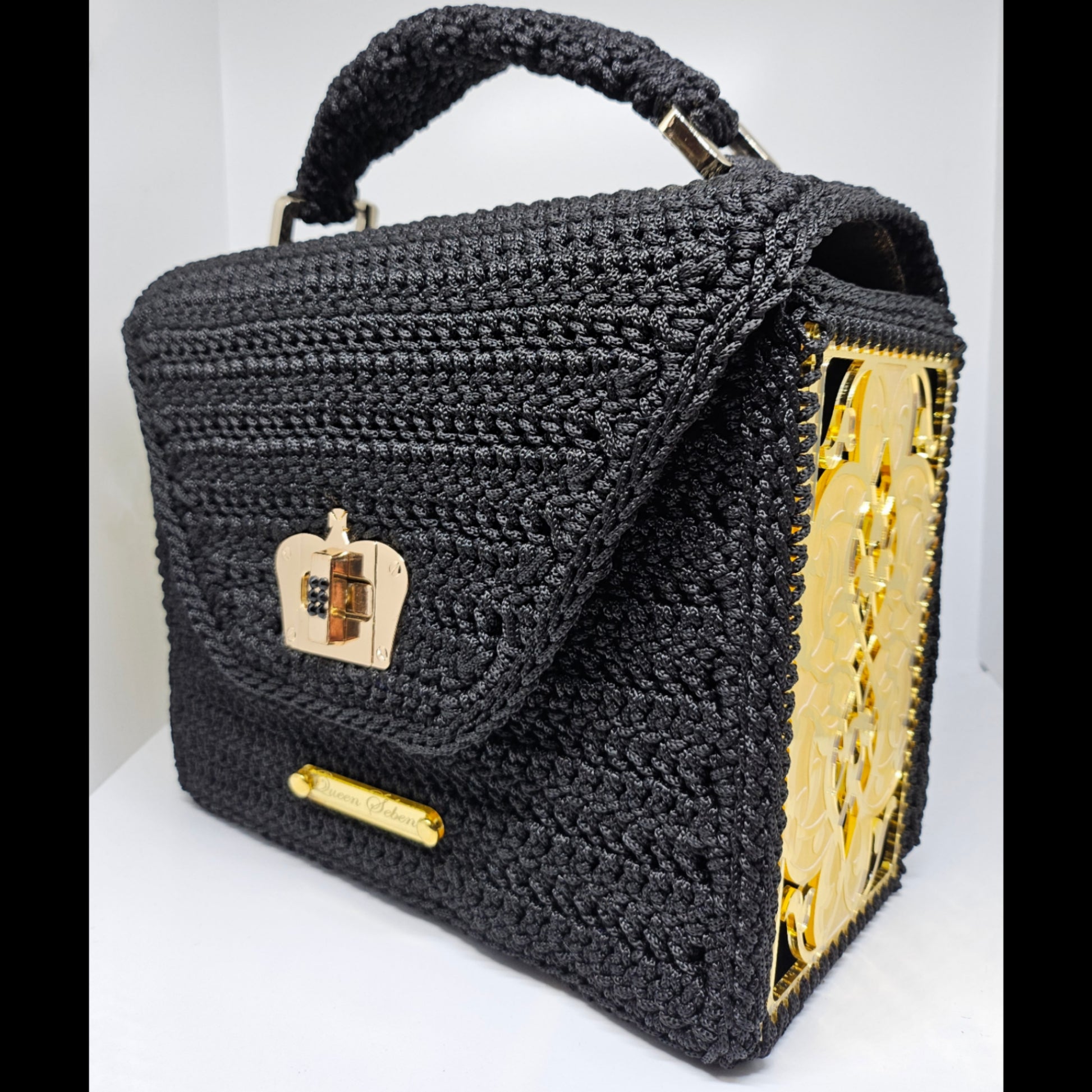 Front side view of Structured black crochet handbag with custom made laser cut acrylic sides