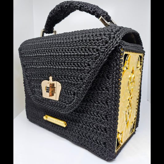 Front side view of Structured black crochet handbag with custom made laser cut acrylic sides