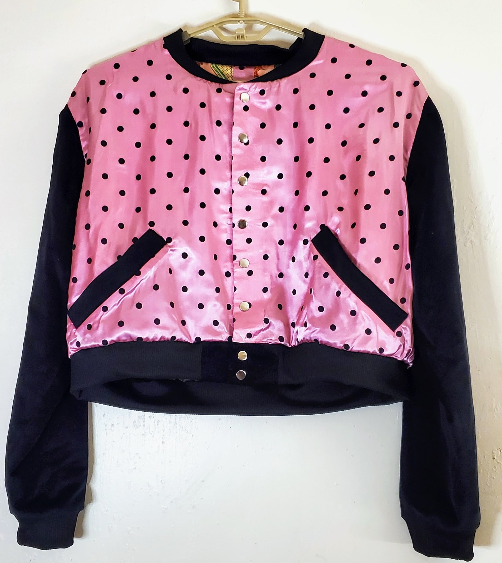 front view of pink polka dot varsity jacket