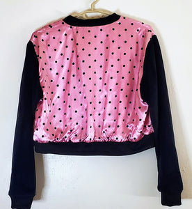 back view of pink polka dot varsity jacket