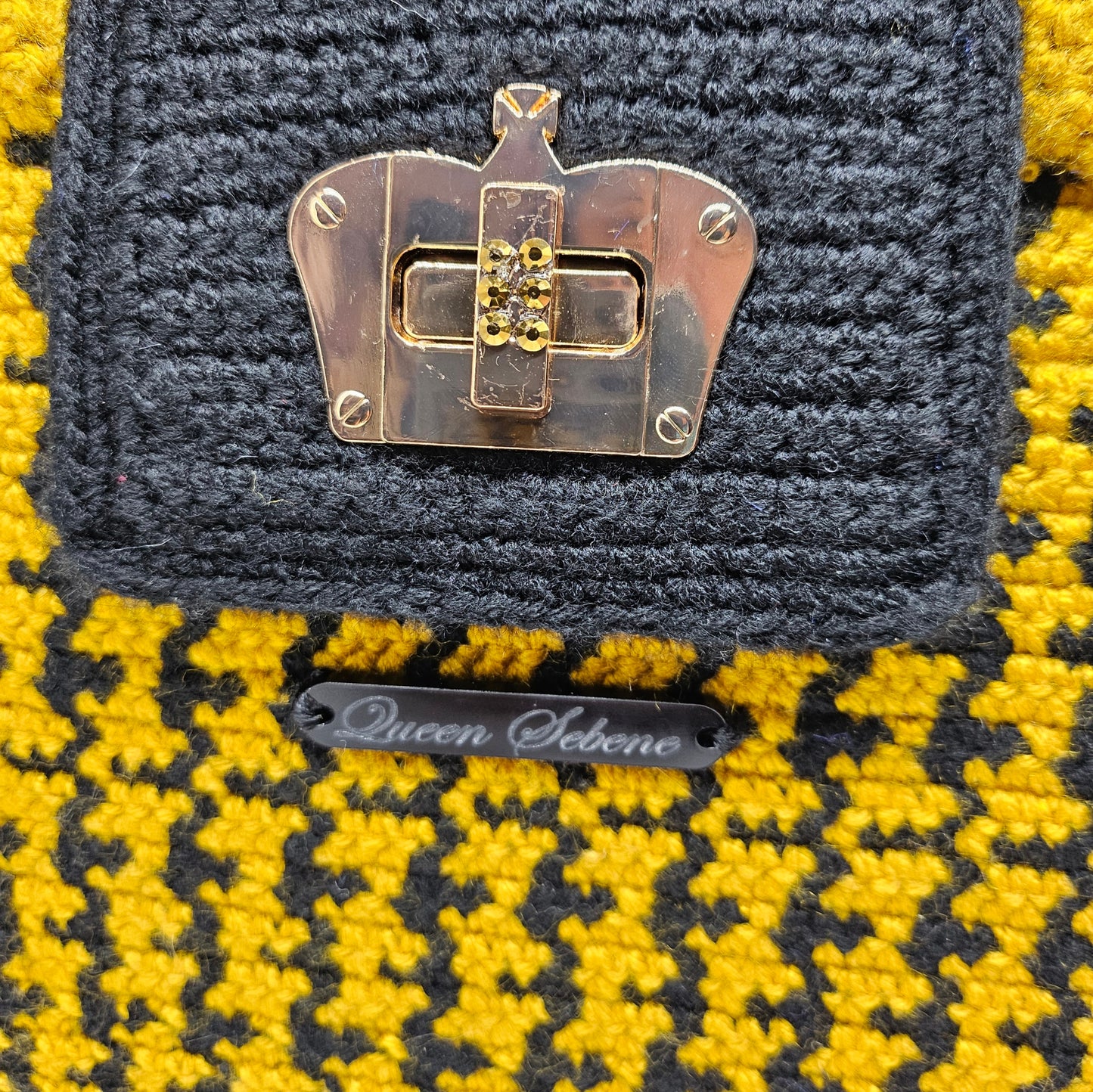 Clasp view of Black and yellow houndstooth structured crocheted handbag