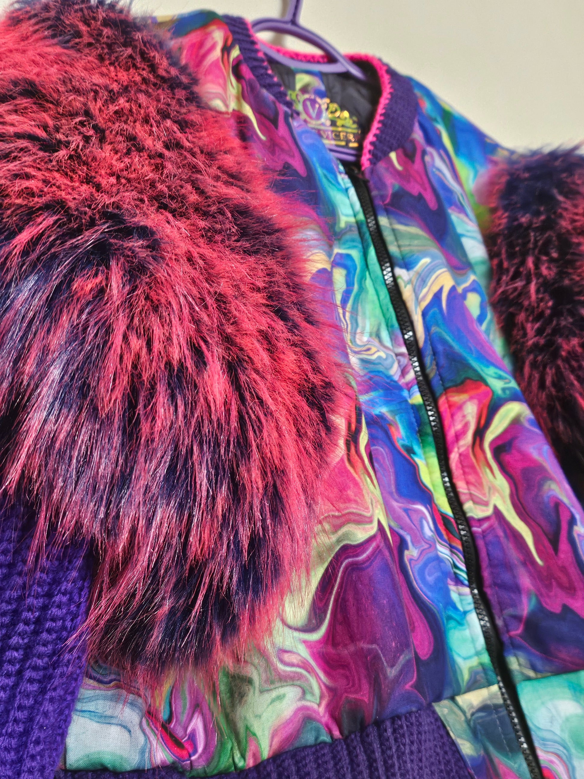 Side front view of Rainbow bomber jacket with faux fur puffed sleeves