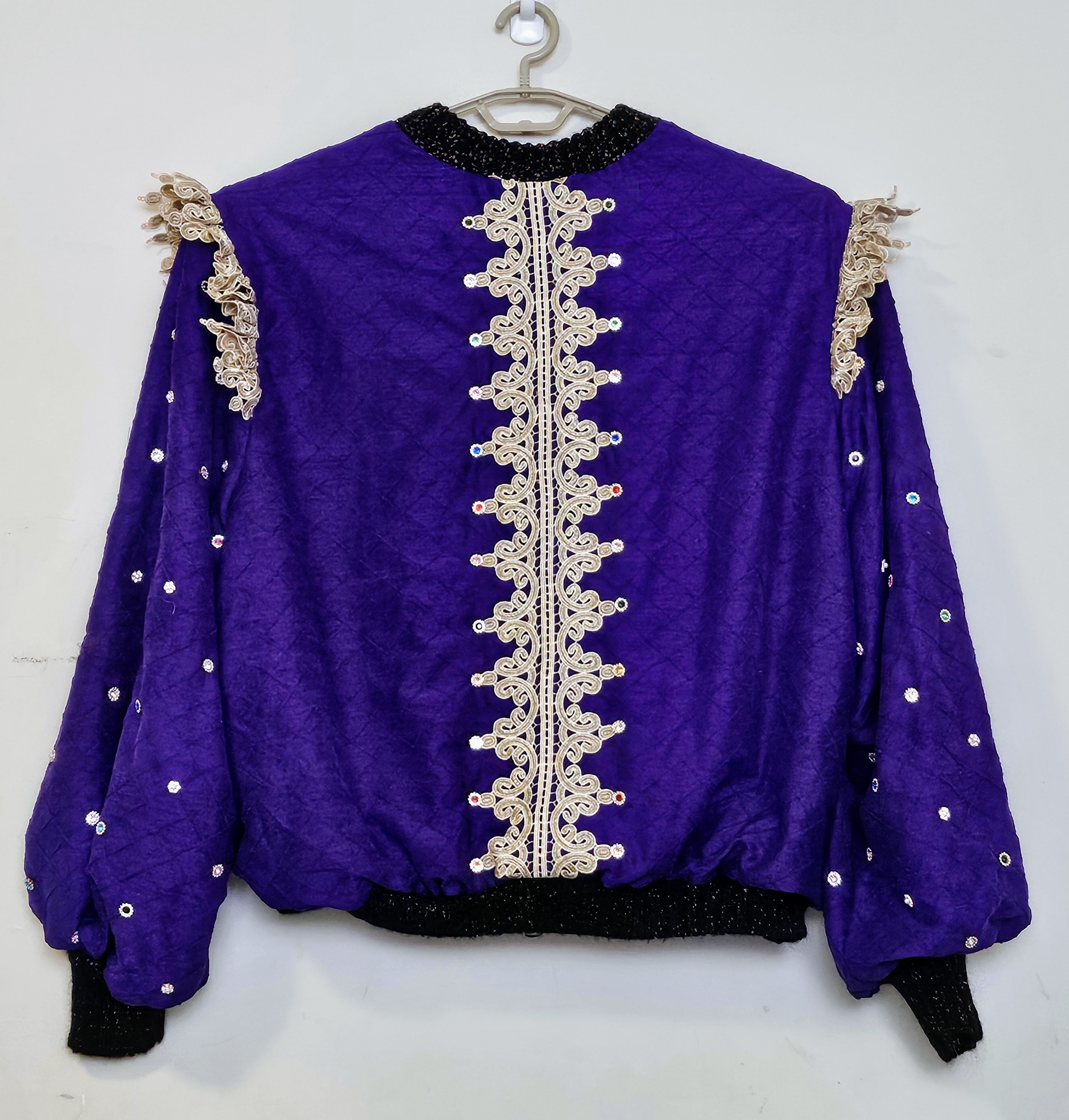 Back view of Rhinestone encrusted purple silk bomber jacket with gold lace accents
