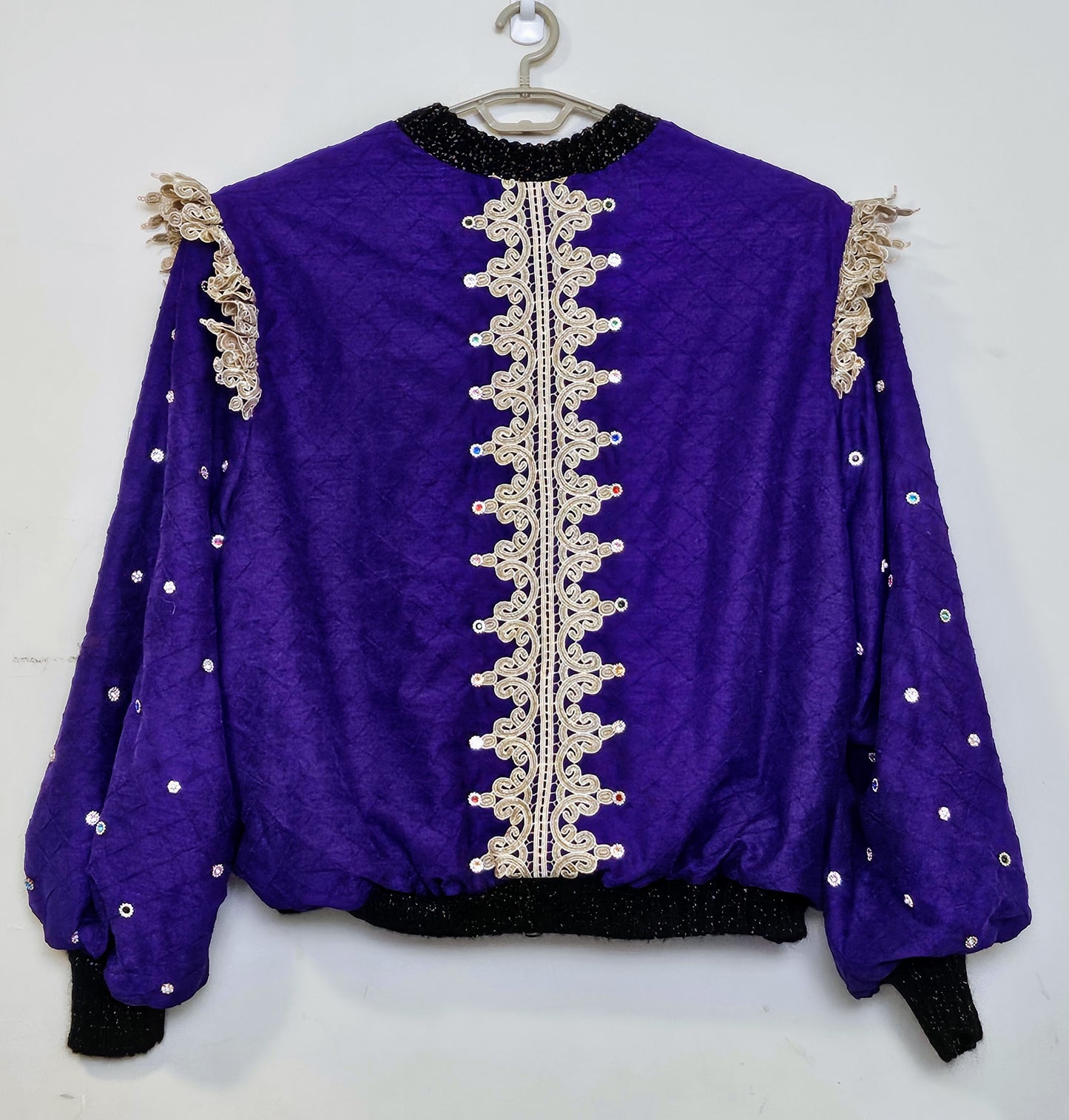 Back view of Rhinestone encrusted purple silk bomber jacket with gold lace accents