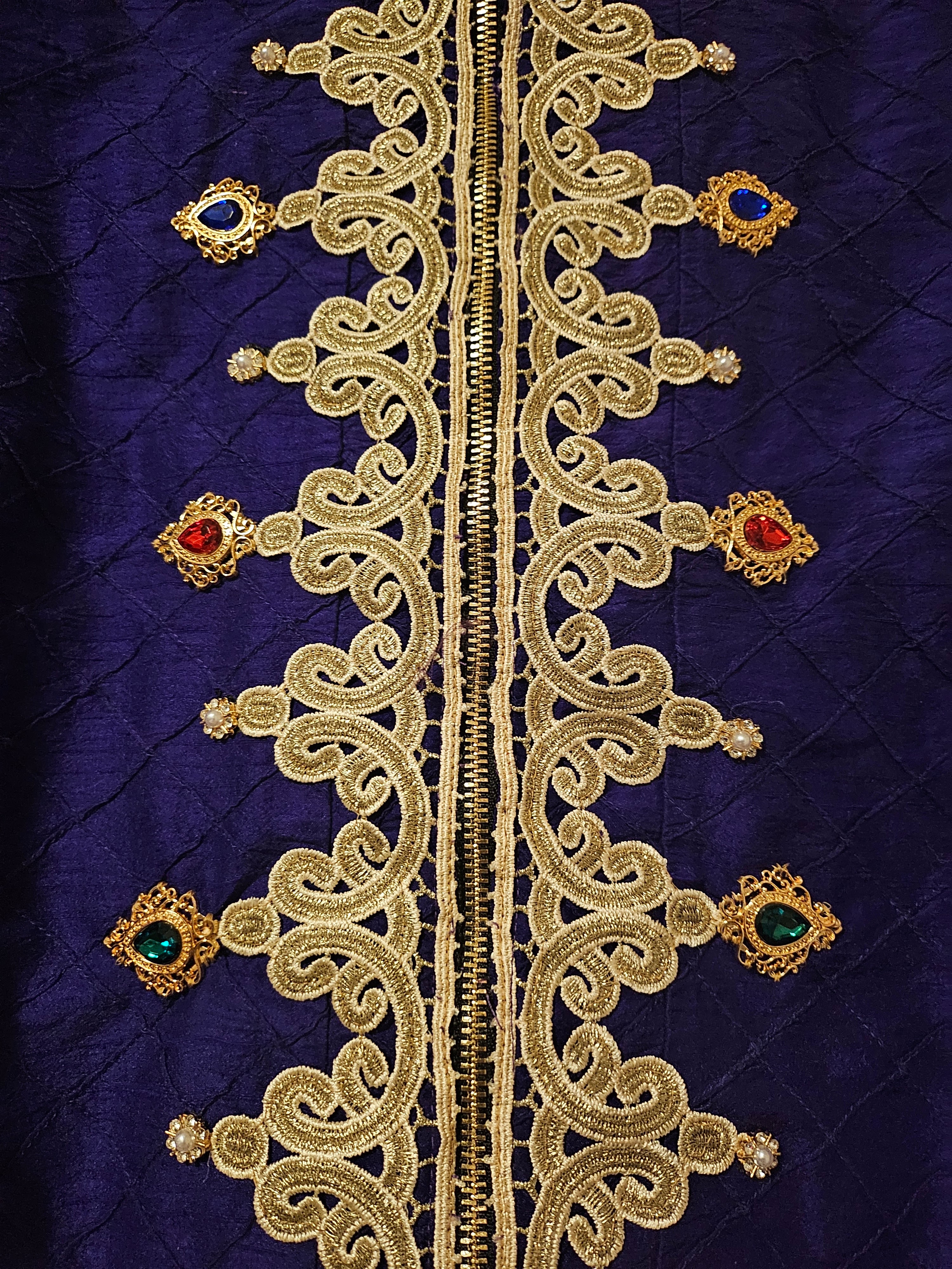 Center front details of Rhinestone encrusted purple silk bomber jacket with gold lace accents