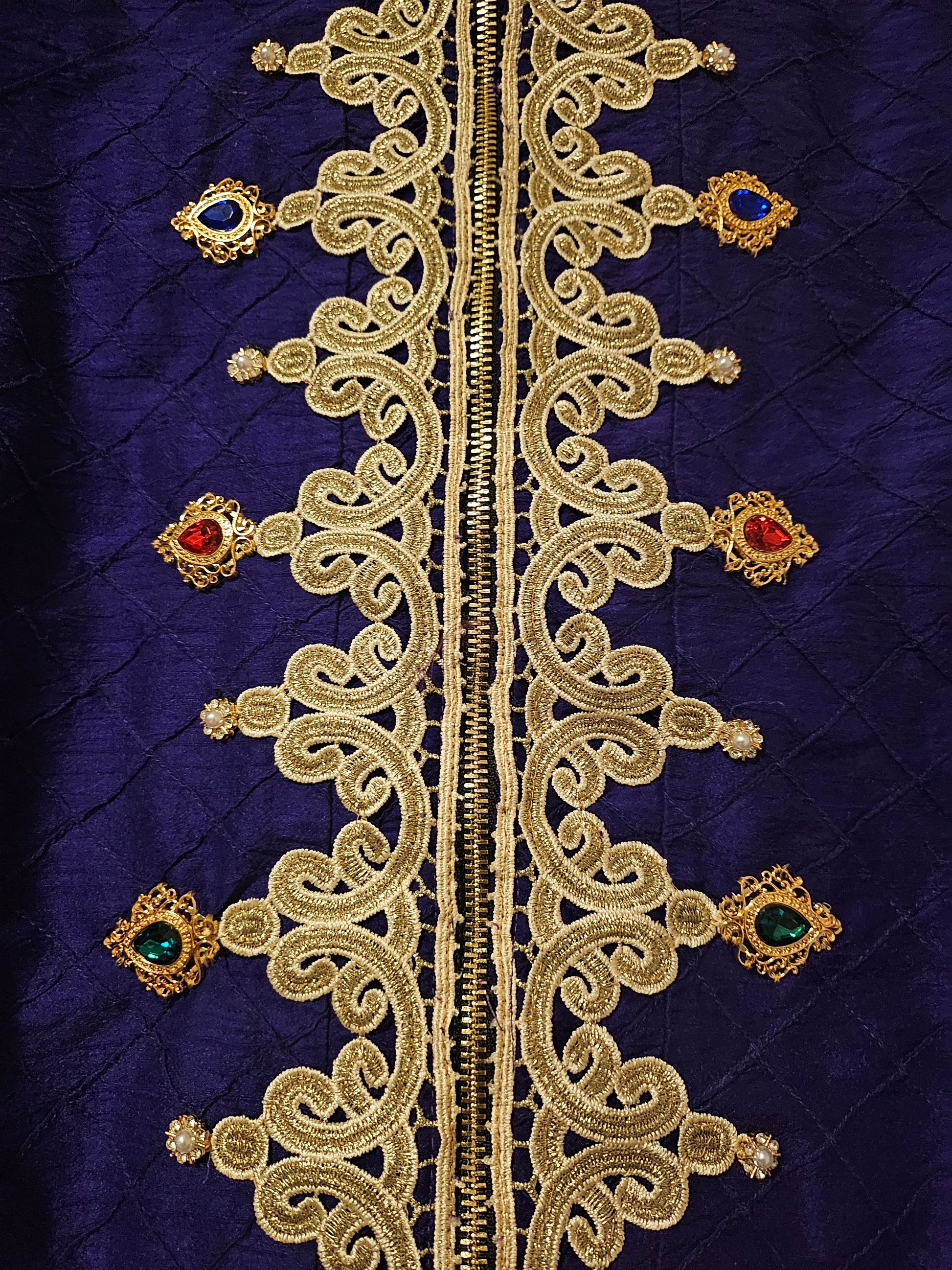Center front details of Rhinestone encrusted purple silk bomber jacket with gold lace accents
