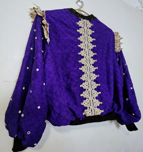 side back view of Rhinestone encrusted purple silk bomber jacket with gold lace accents