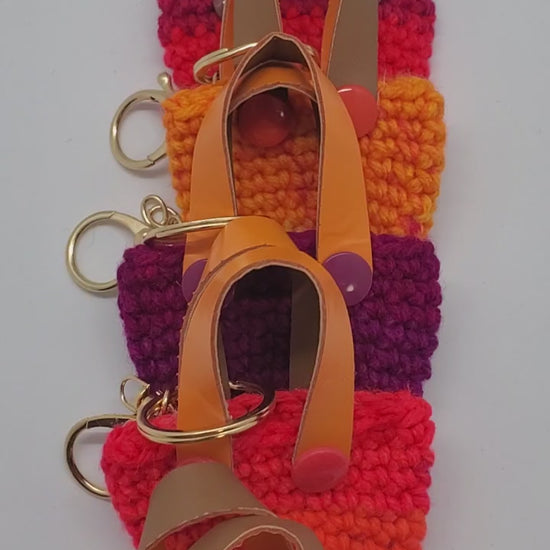 video of orange with purple Crochet mini tote keychains with vinyl handles