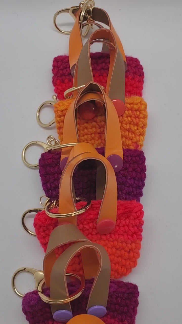video of orange with purple Crochet mini tote keychains with vinyl handles