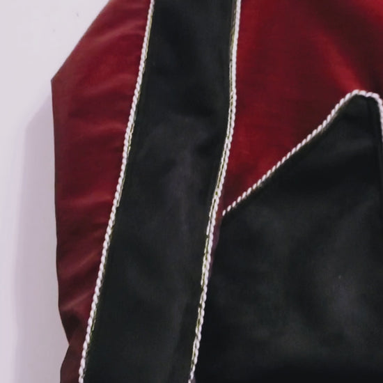Video of red taffeta and black velveteen colour-blocked bomber jacket with white cord piping