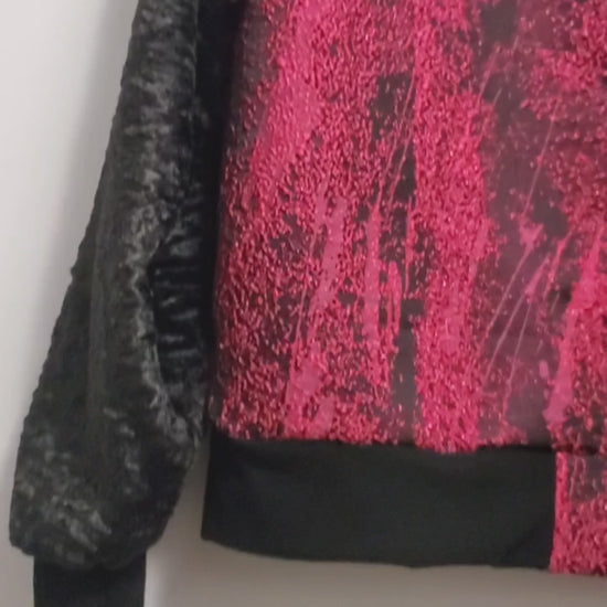 video of Fuchsia and black bomber jacket with faux fur sleeves and sequin applique details