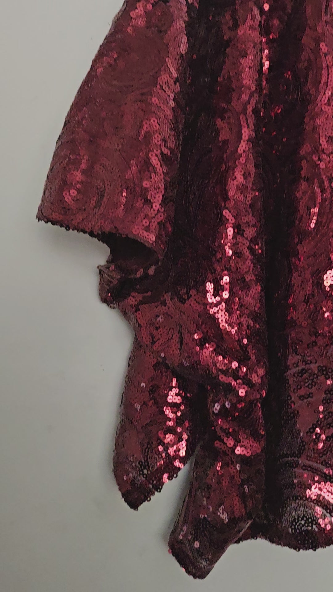 video of Burgundy sequin kimono jacket with black embroidered shoulders on hanger