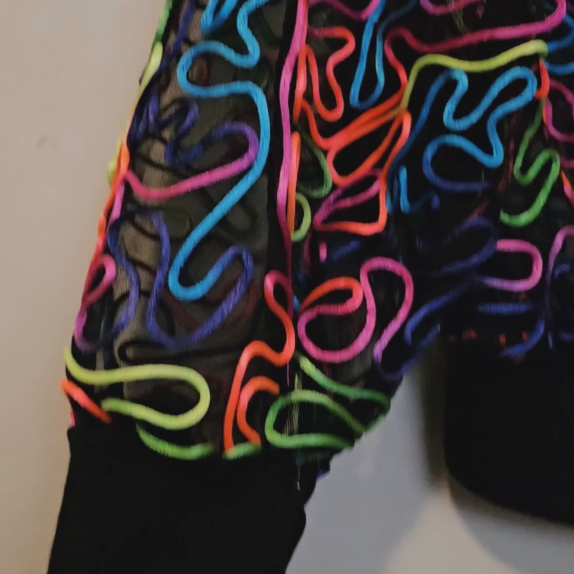 Video of rainbow embroidered mesh bomber jacket