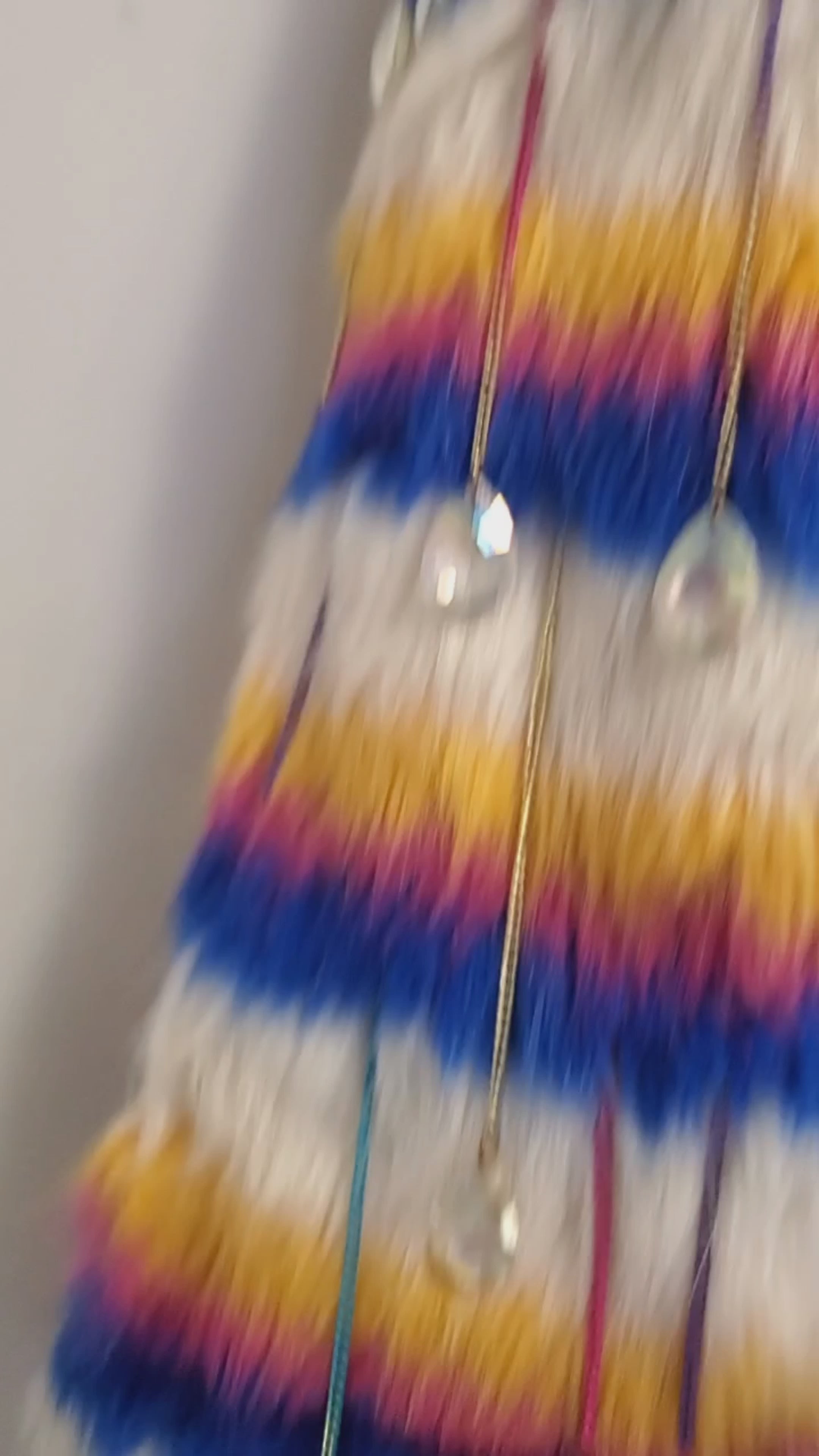 video of white rainbow striped faux fur coat with chain details