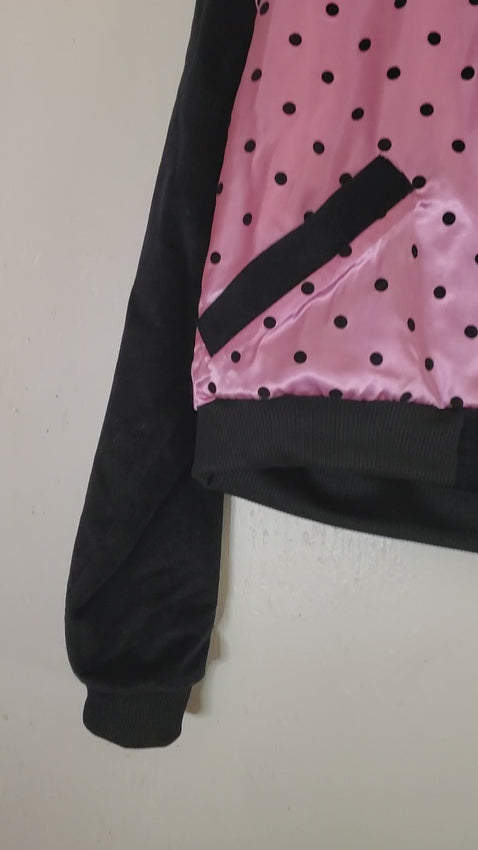 video of pink polka dot varsity jacket
