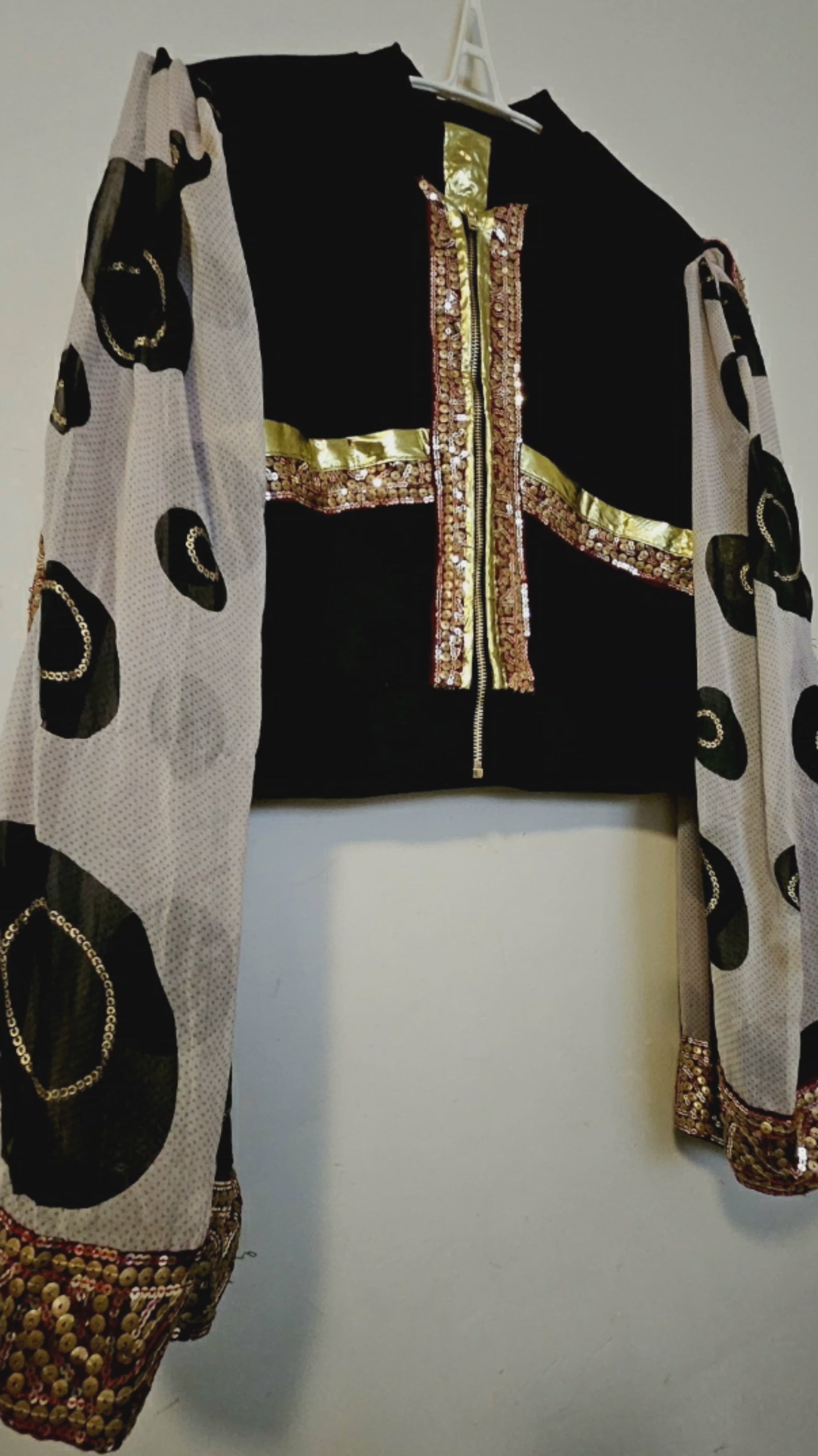 Video of Indian inspired bomber jacket with sheer cape sleeves