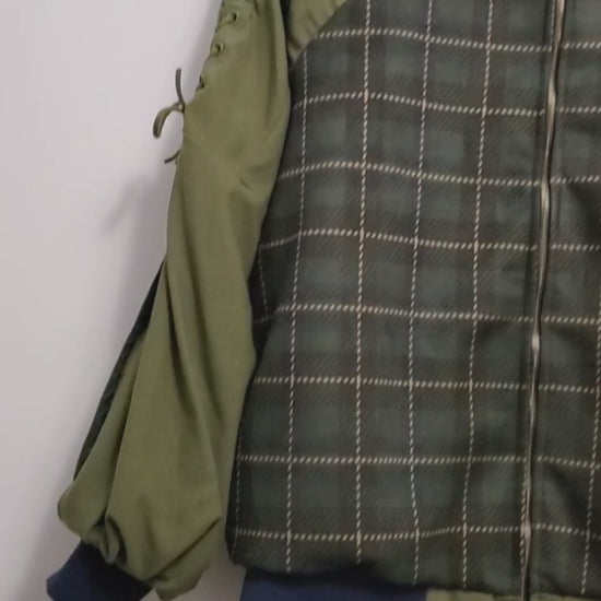 video of Forest green plaid bomber jacket with split sleeves and laced shoulder details.