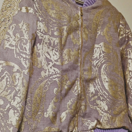 Video of the front of Lilac linen blend embossed with a golden baroque pattern