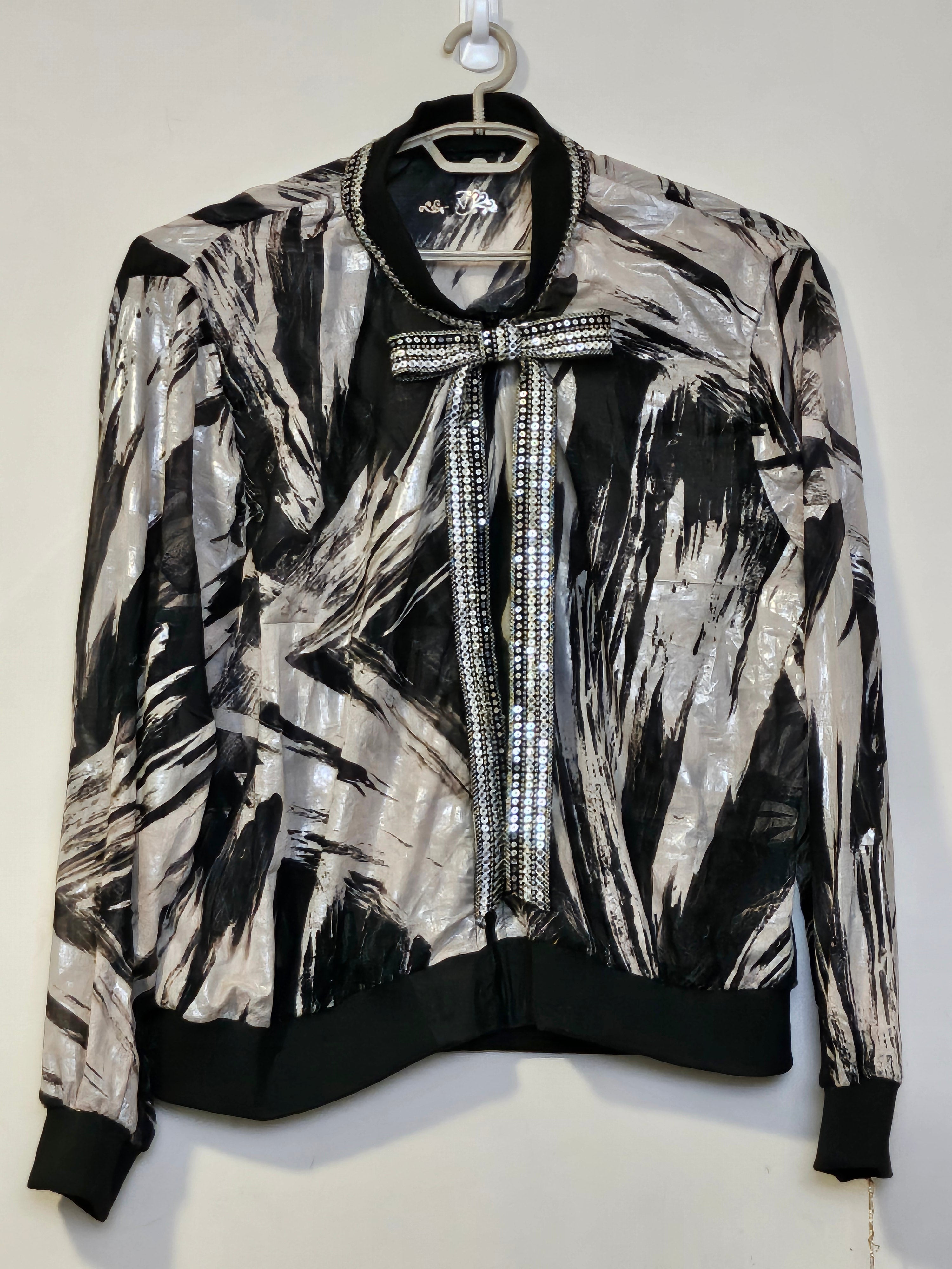 Front view of Sheer abstract printed bomber jacket with bowtie detail