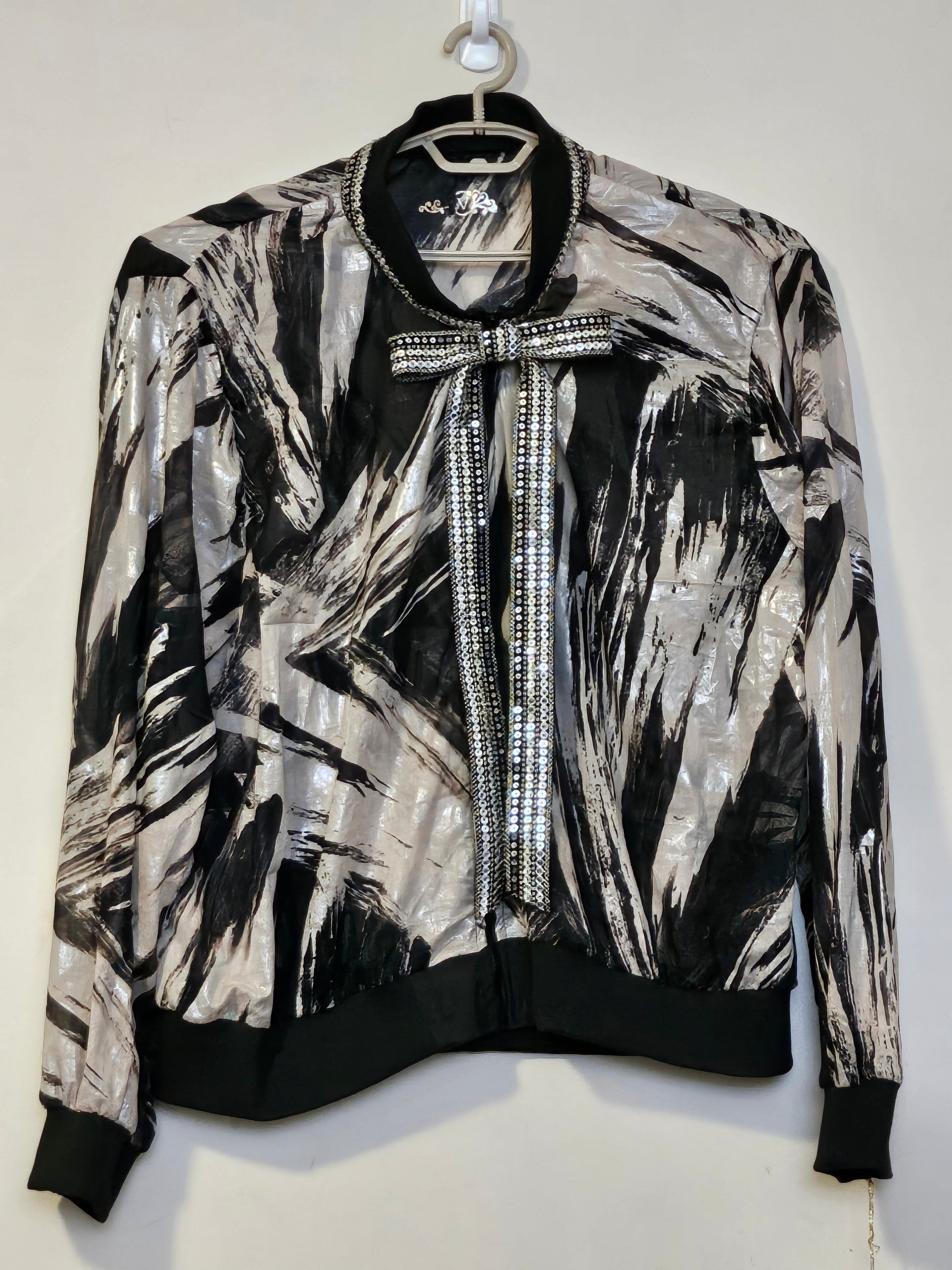 Front view of Sheer abstract printed bomber jacket with bowtie detail