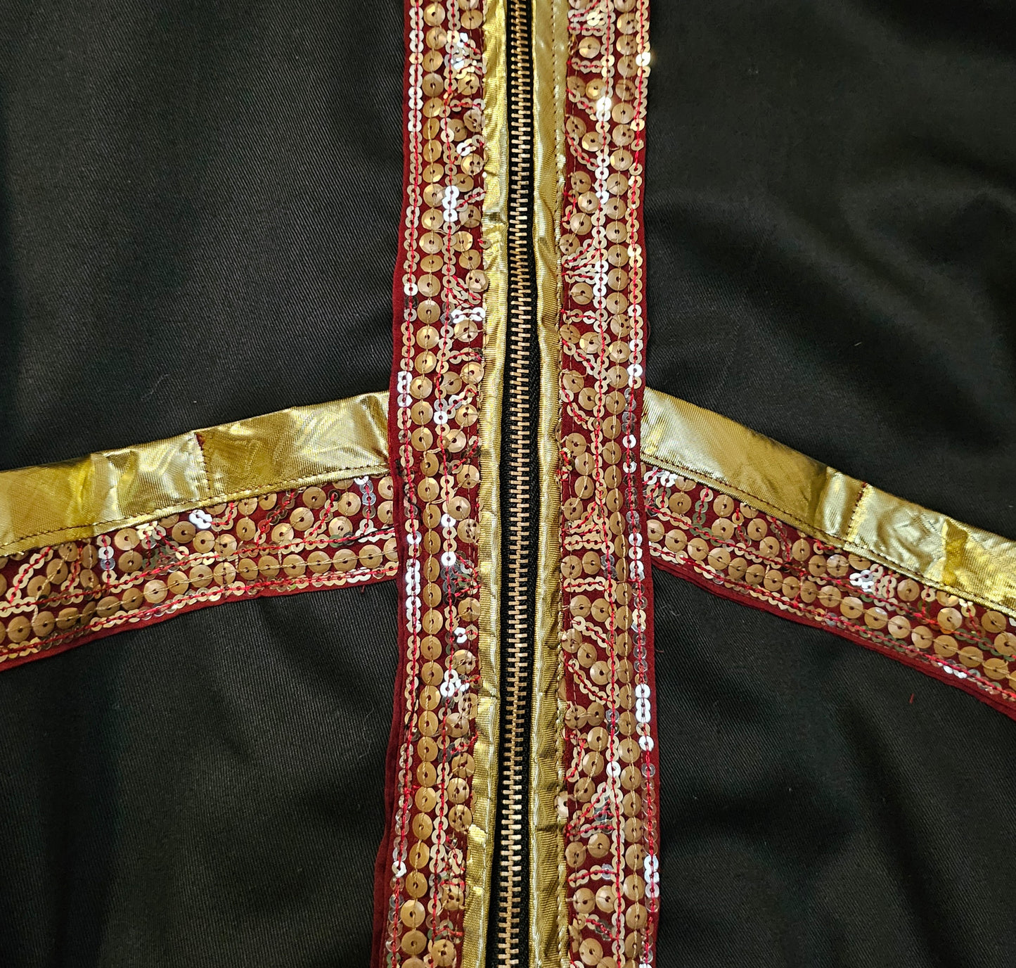 Front bodice detail of Indian inspired bomber jacket with sheer cape sleeves