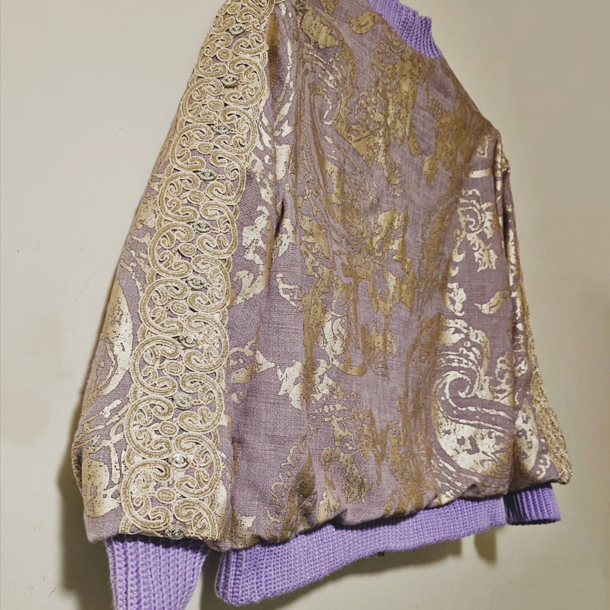 Side back view of Lilac linen blend embossed with a golden baroque pattern